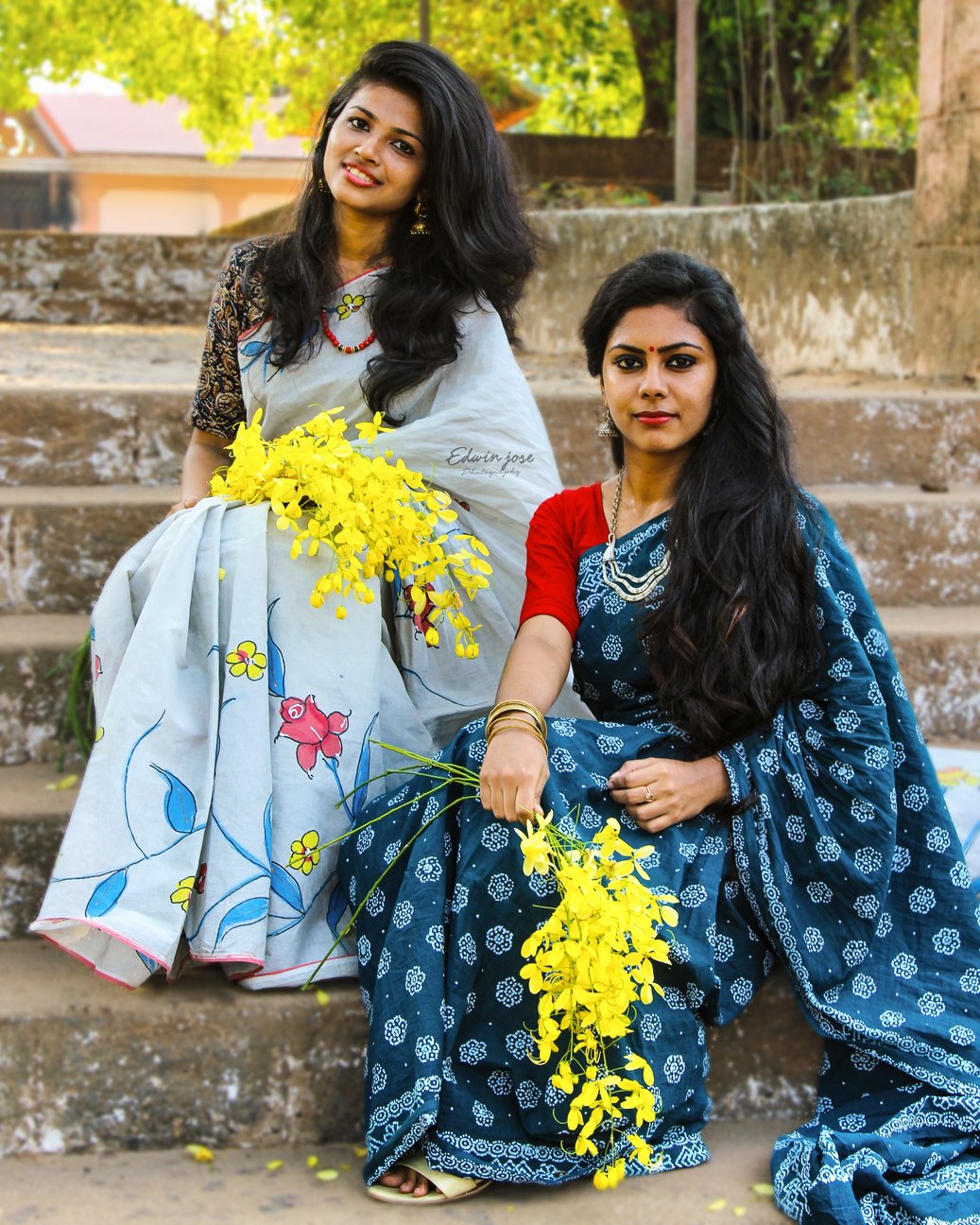 Gorgeous young Indian women in sari on street steps